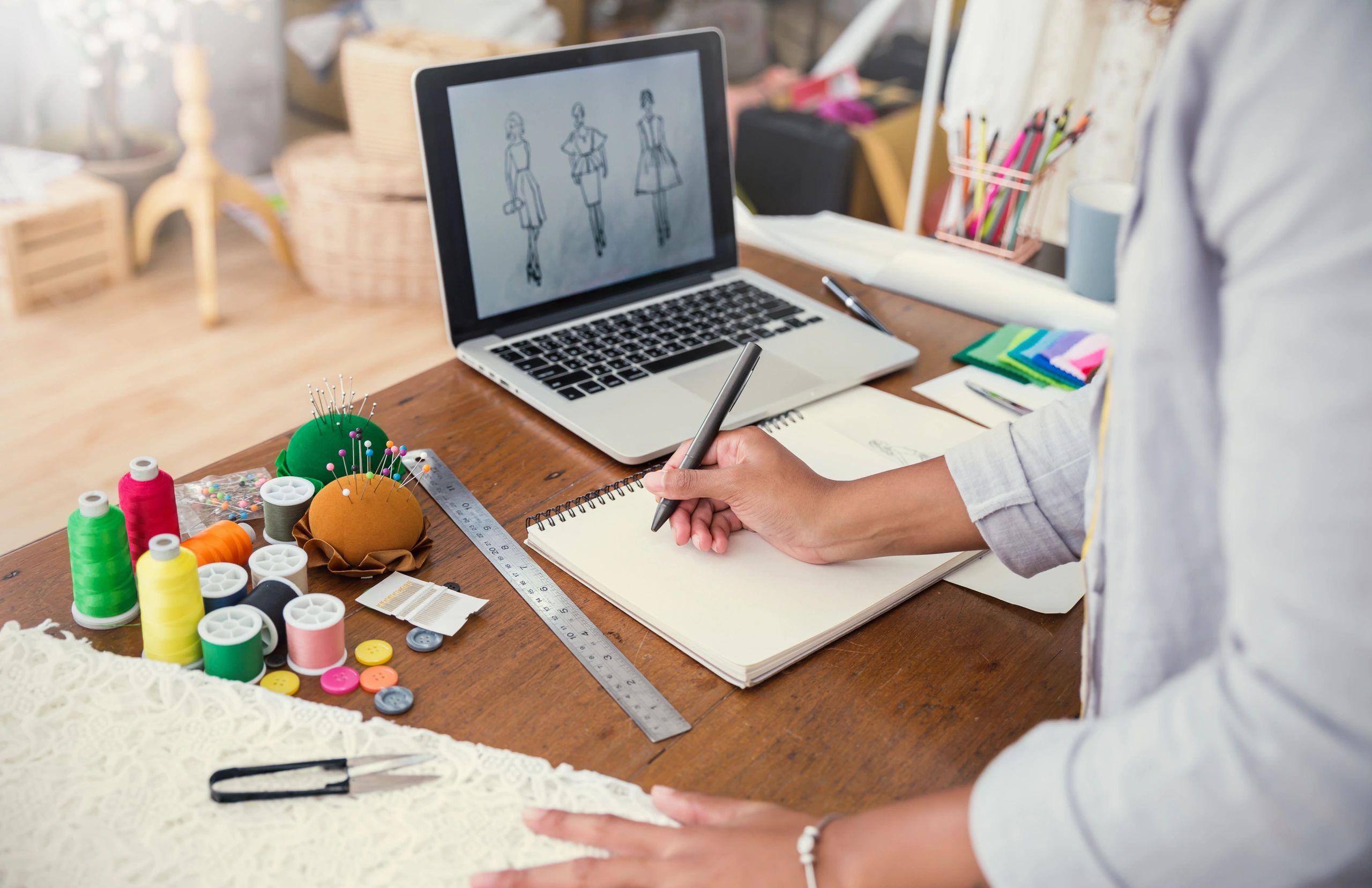 Top view of fashion designer working on pattern making at a desk