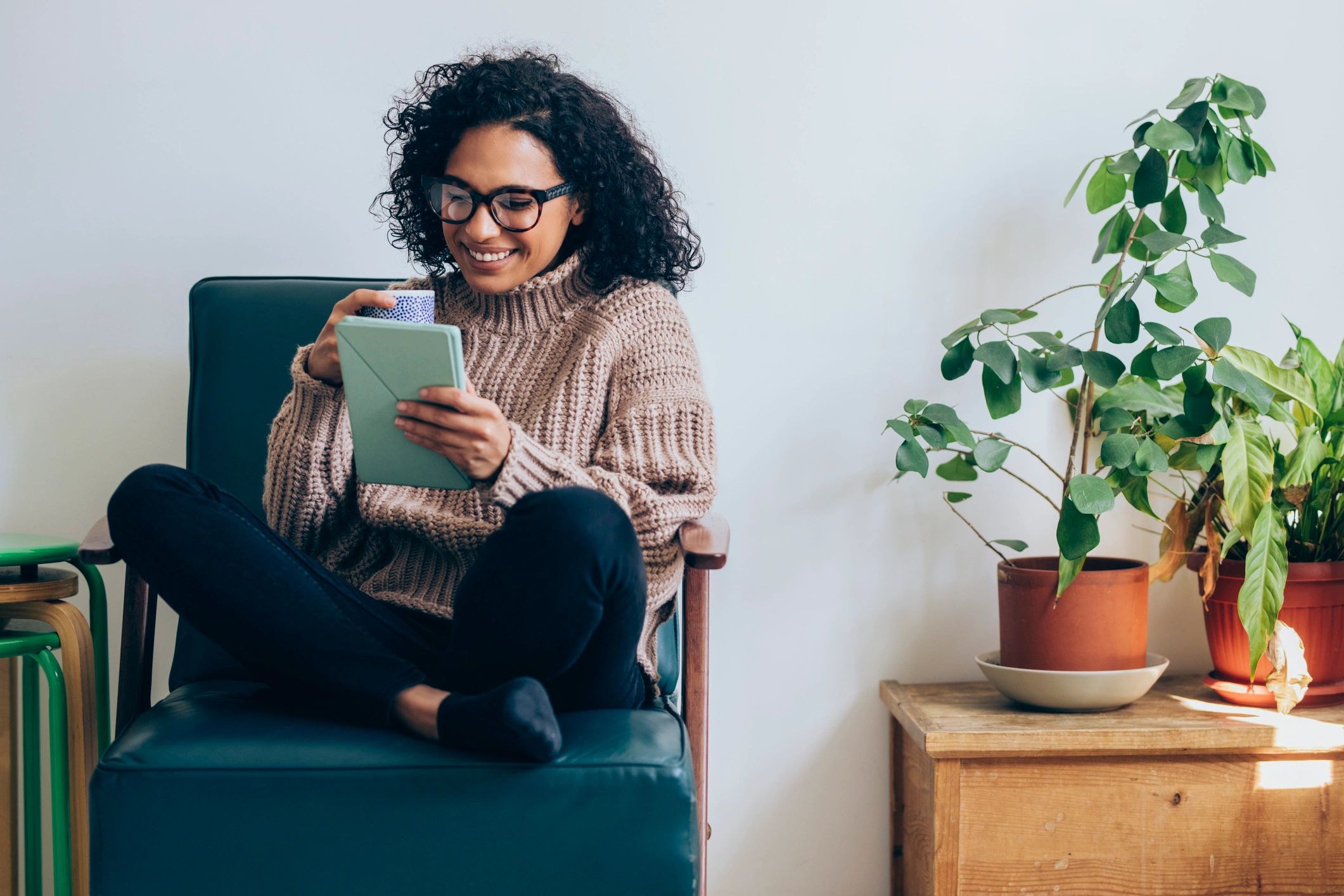 Woman reading on a digital tablet at home